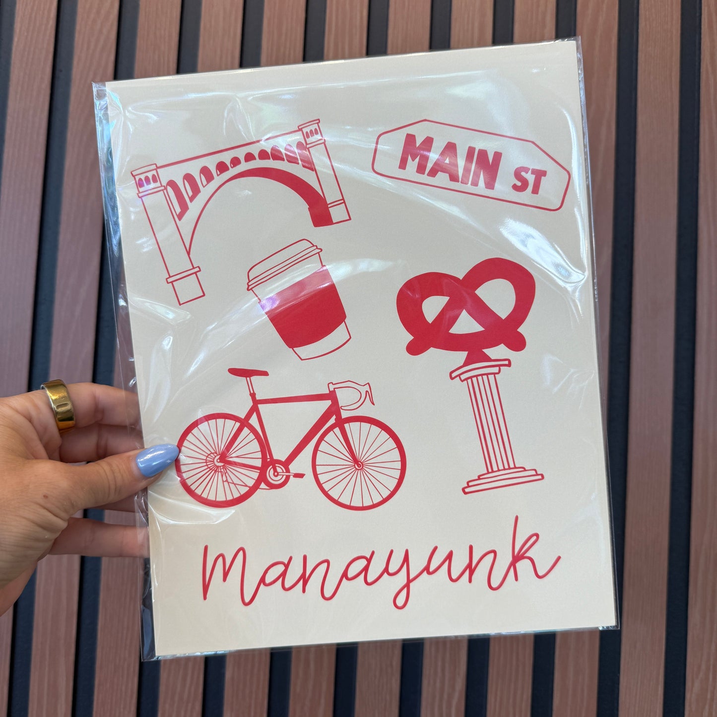 Packaged product with red graphics and text on a wooden surface